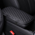 Black quilted center console armrest cover installed in a vehicle