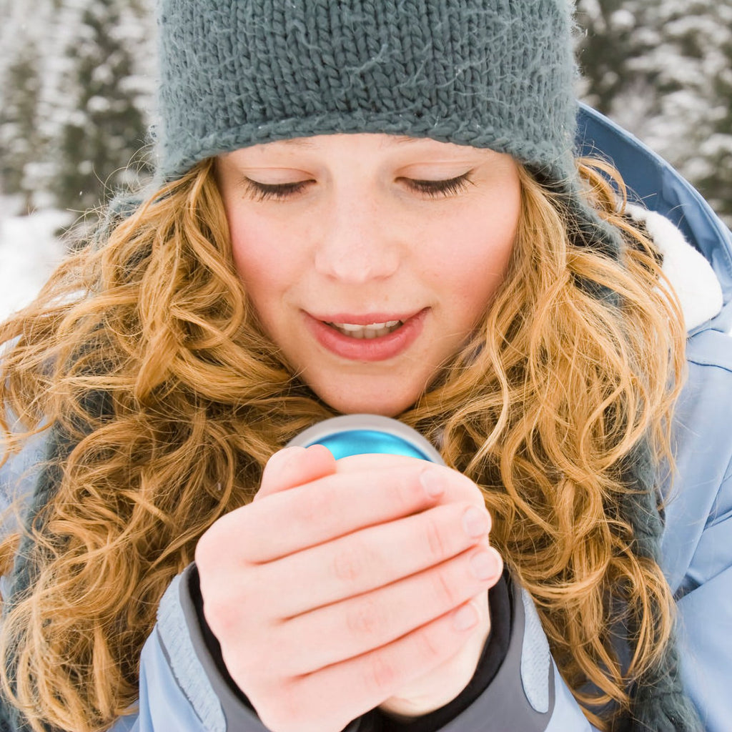 Blue pocket hand warmer used outdoors in cold weather