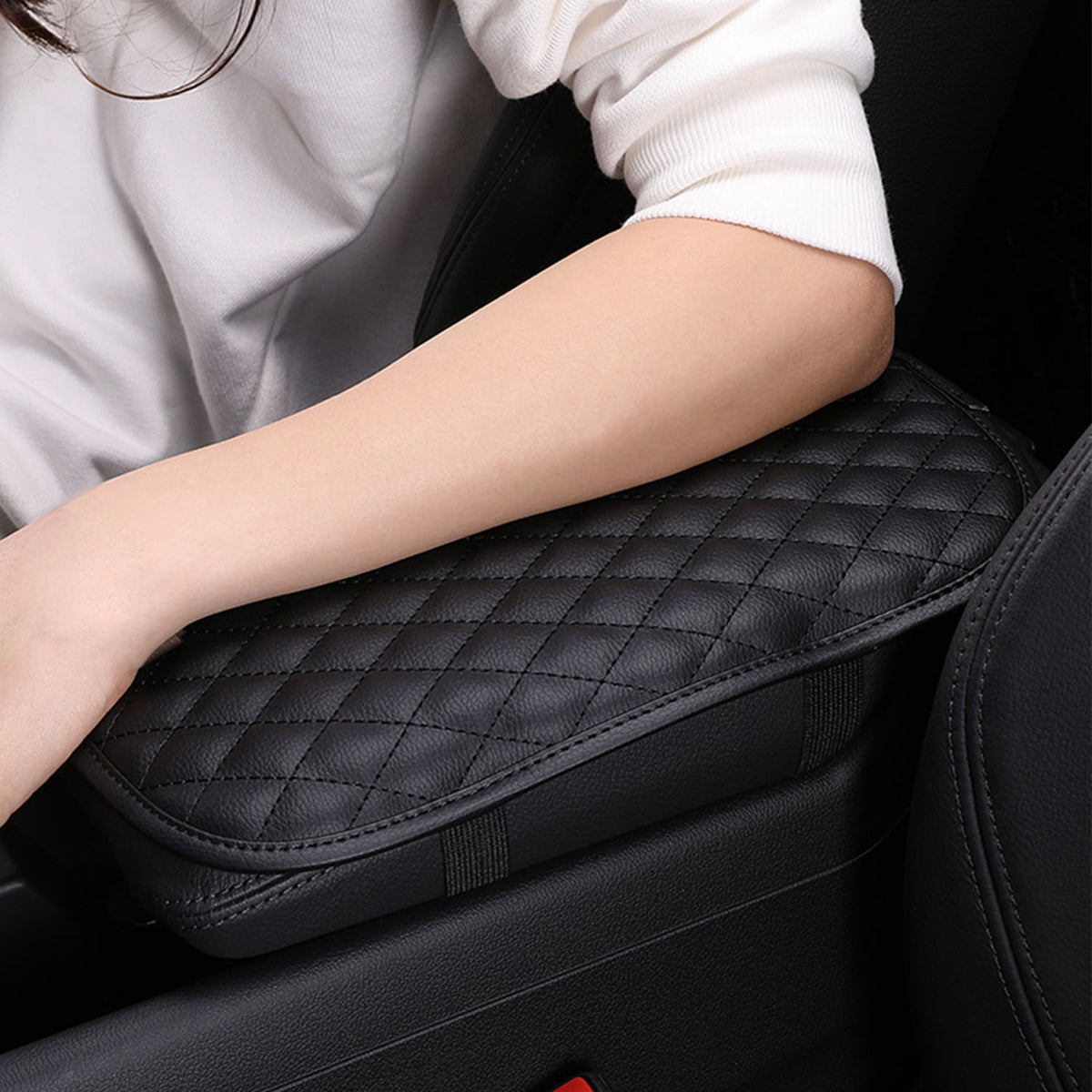 Black console cover providing a padded surface for the arm